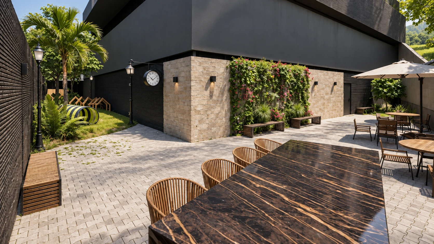 Pátio com mesas, parede verde e acesso ao jardim para pets.